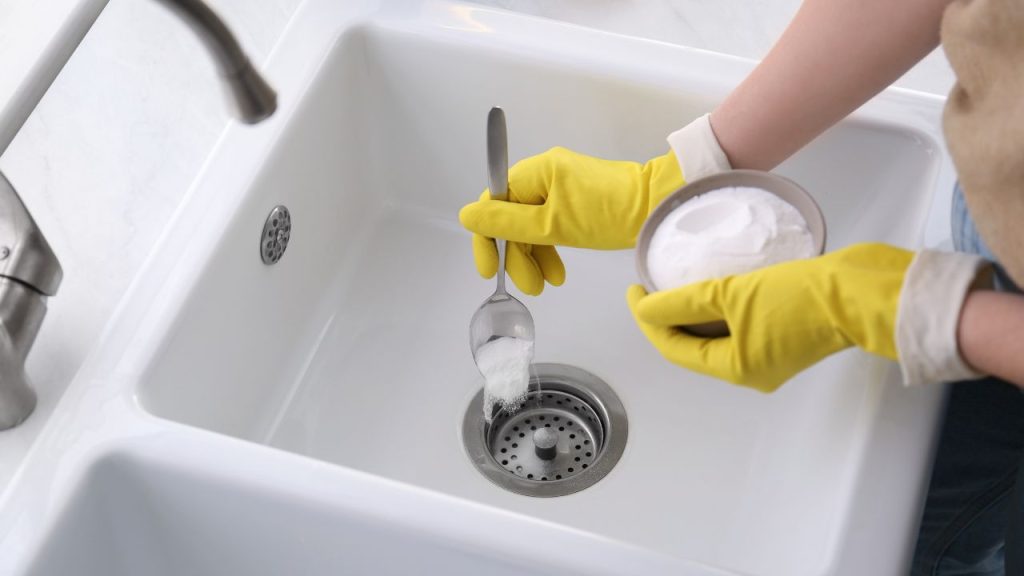 Flush out old debris with hot water and baking soda