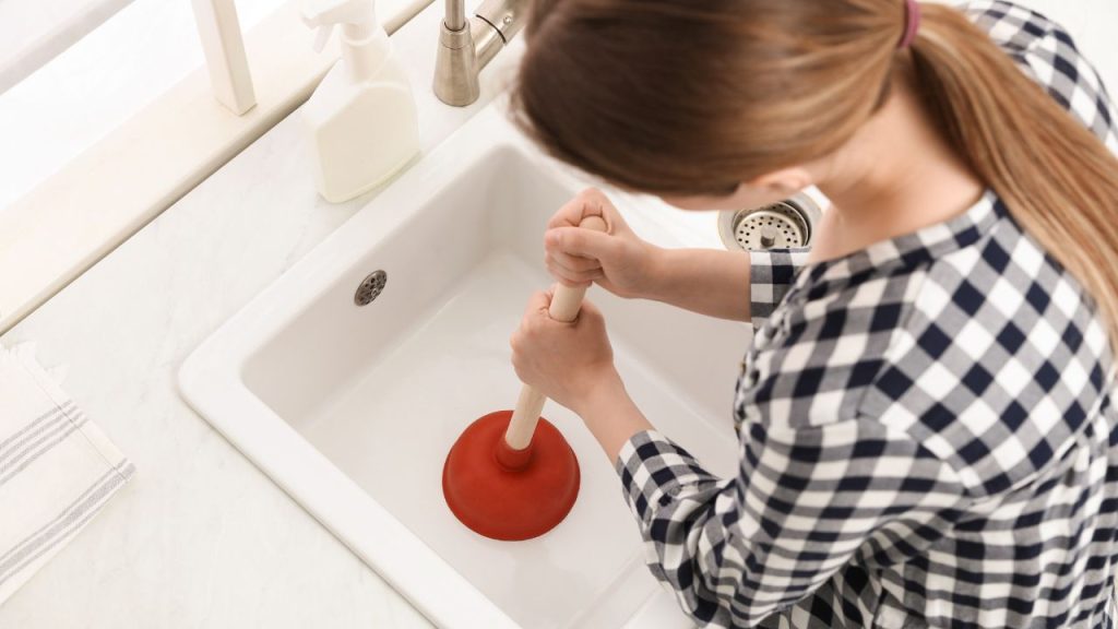 Use a plunger or pliers to remove the clog from the drain