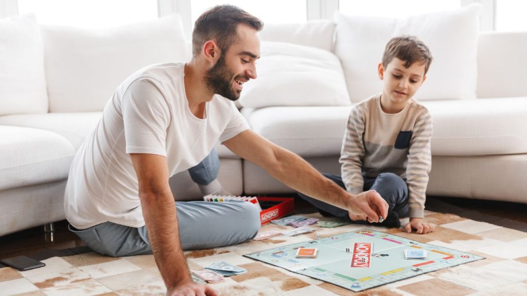kids and father playing monopoly games